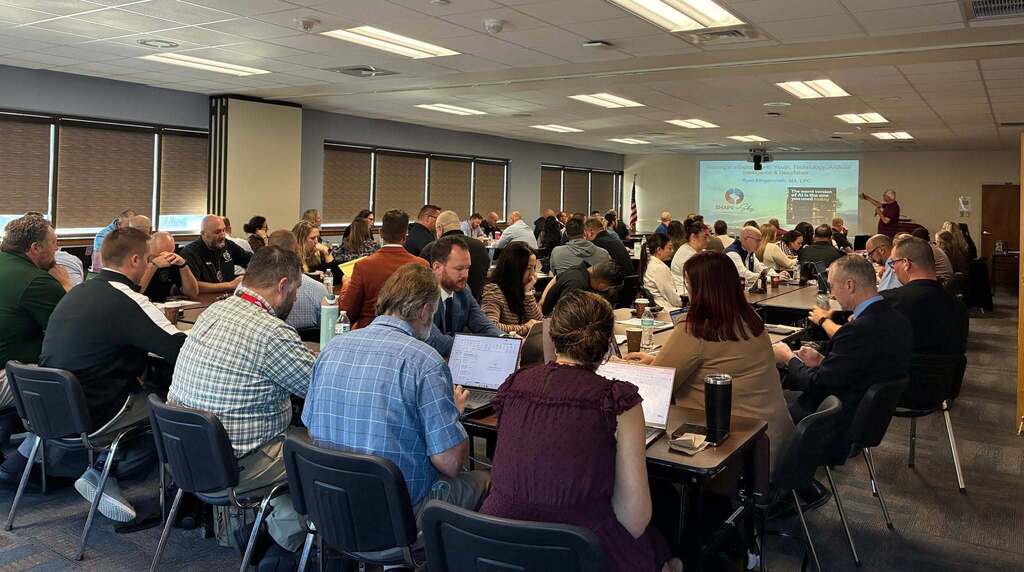 Conference room with attendees watching presentation 