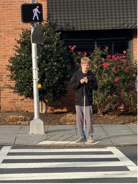 Jackson H., a student from the Wyomissing Area SD, demonstrates safe street crossing techniques while his instructor observes from a distance.