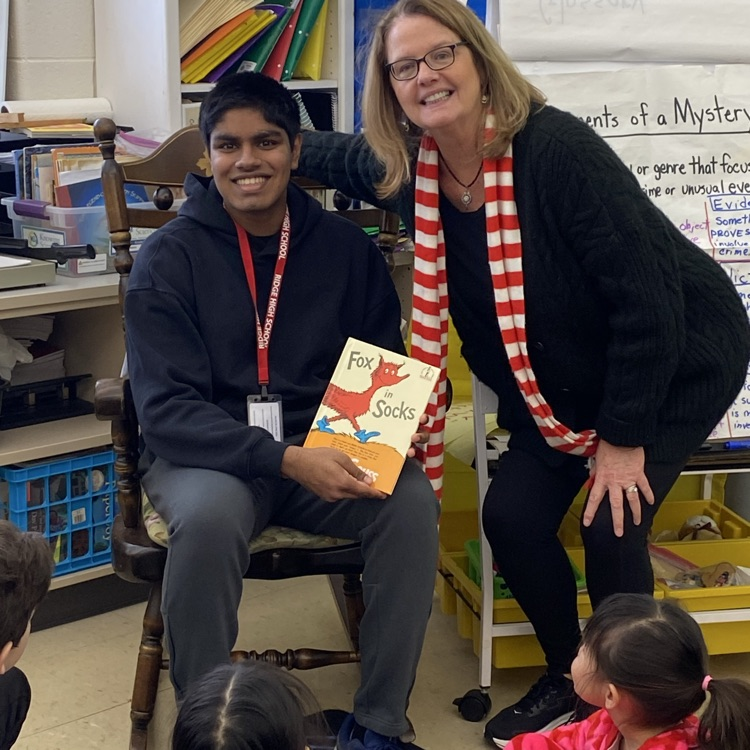 junior with teacher reading
