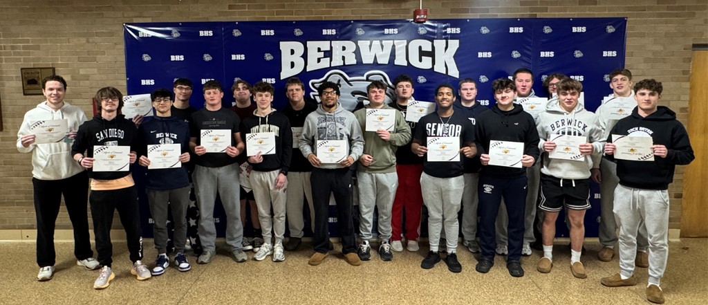football players standing in a group with certificates