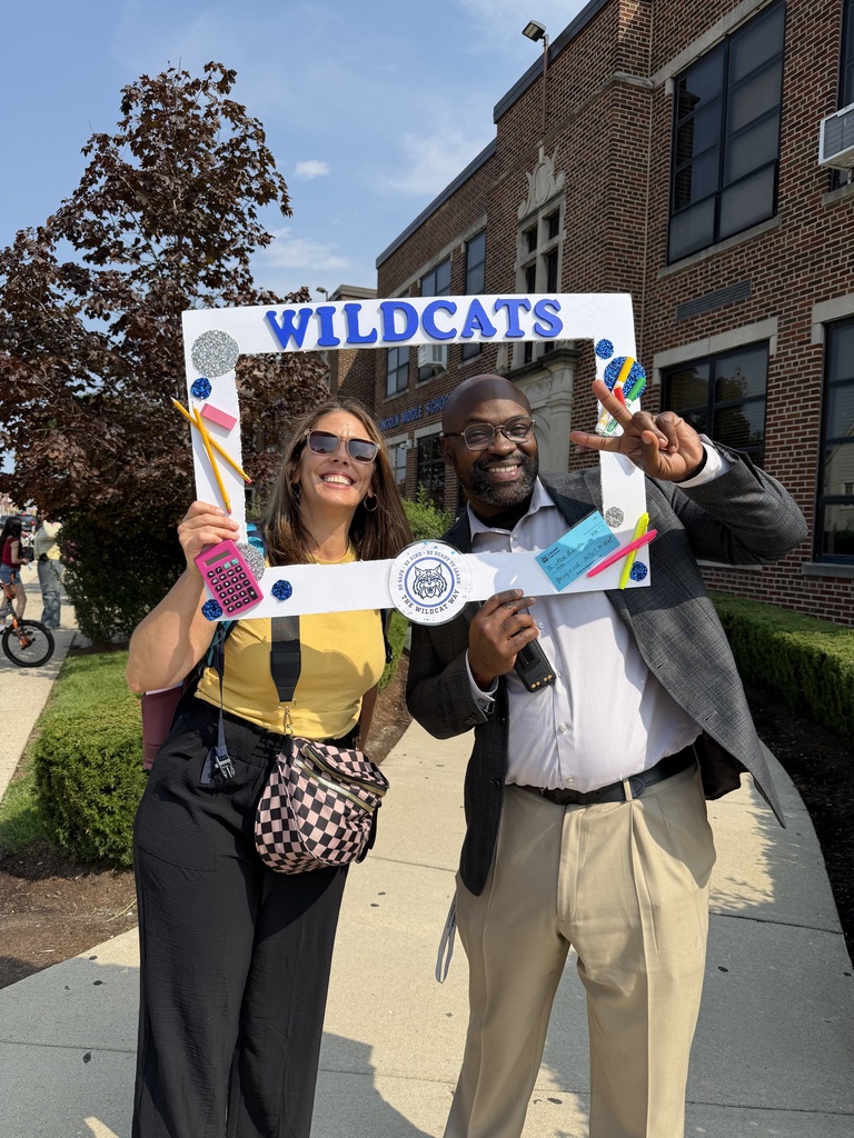 principal and teacher holding wildcats photoframe