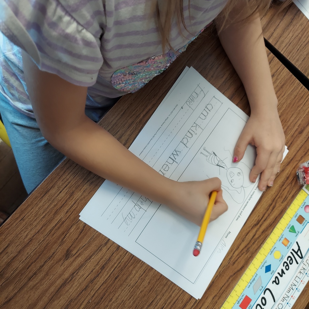 Student writing and drawing