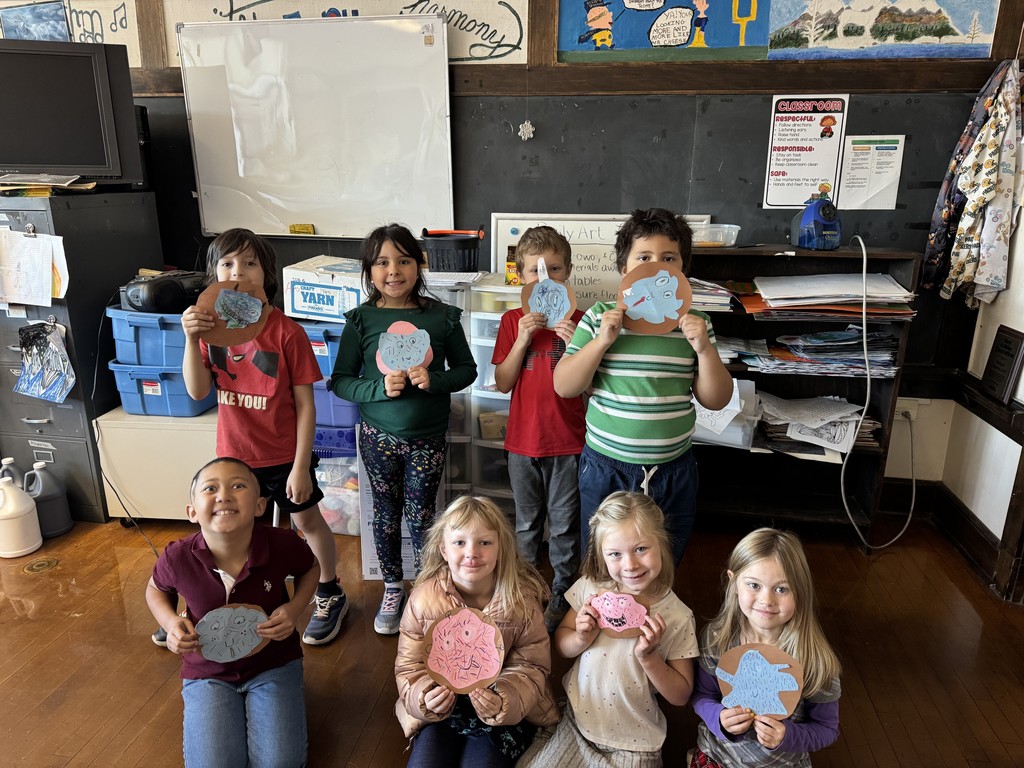 students holding crafted donuts
