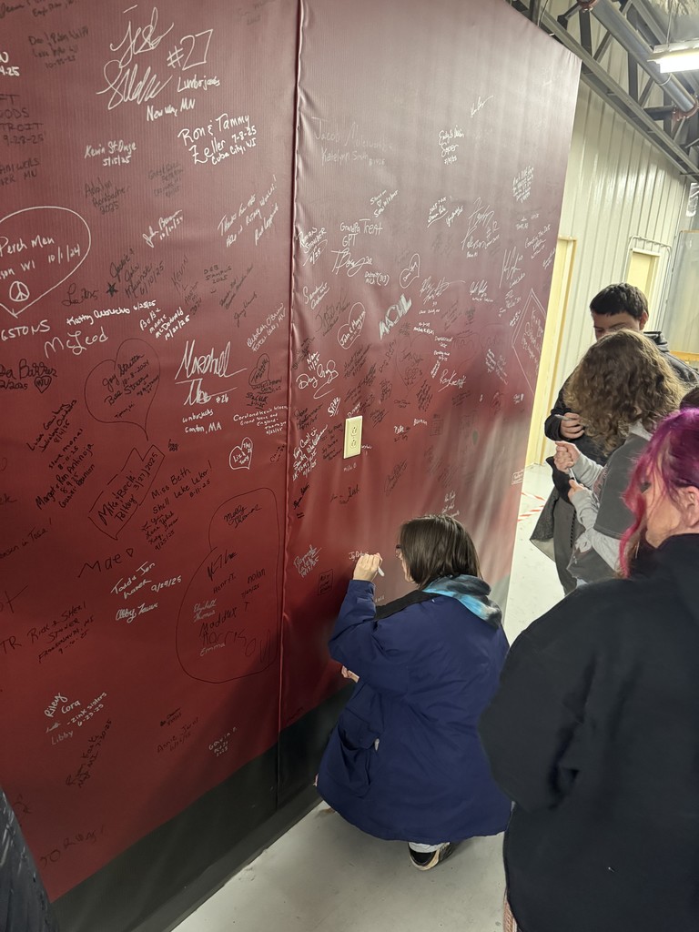 Students writing on wall