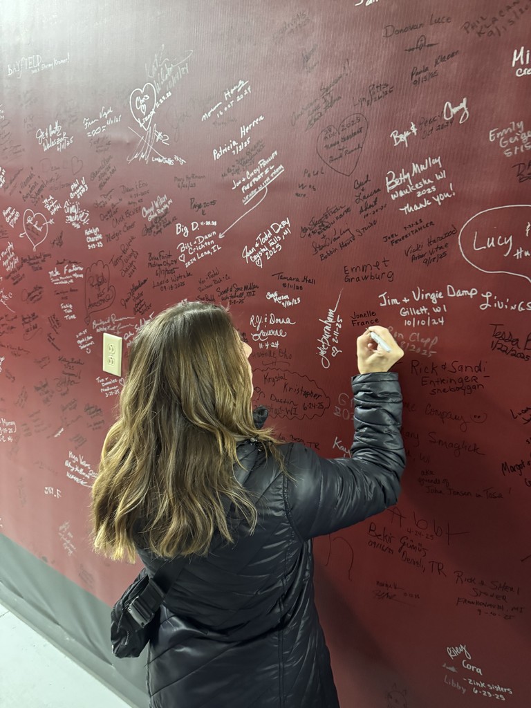 Teacher writing on wall