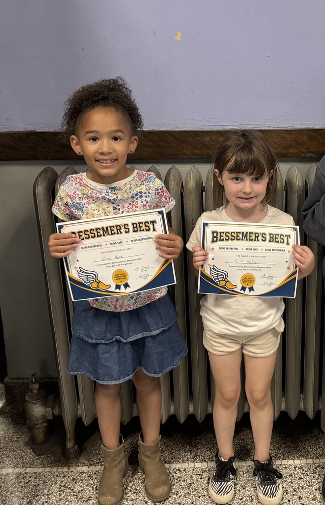 2 girls holding certificates for Bessemer's Best awards