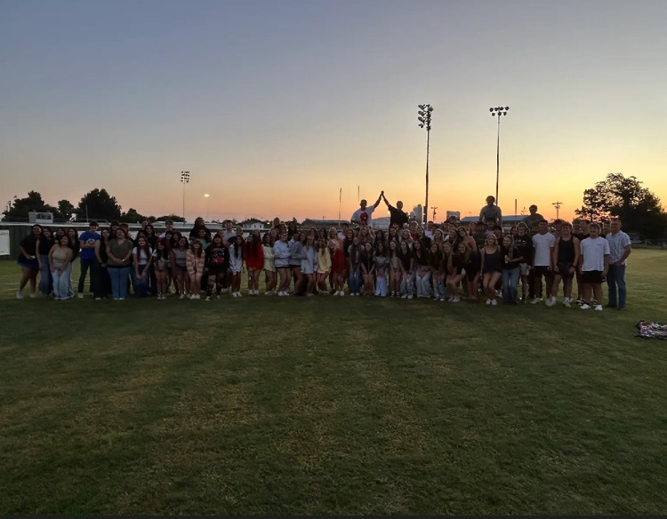 seniors on the field at sunrise