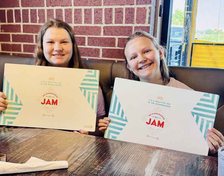 Students holding books on a field trip
