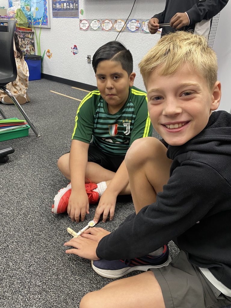 2 boys with a catapult