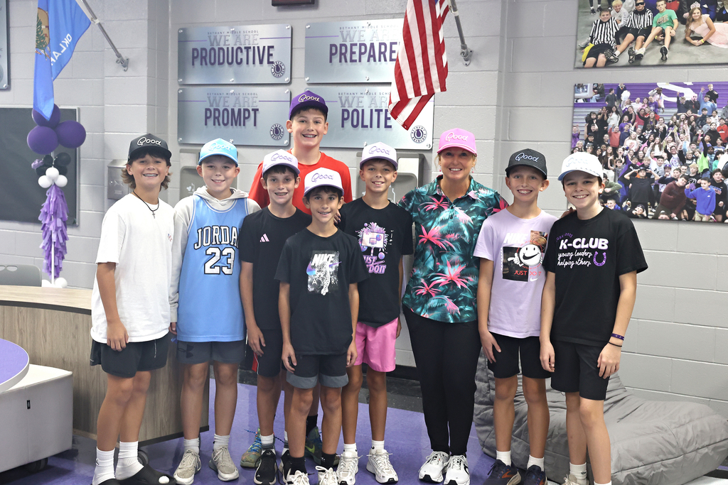 100225 picture of students and teacher all wearing matching golf hats