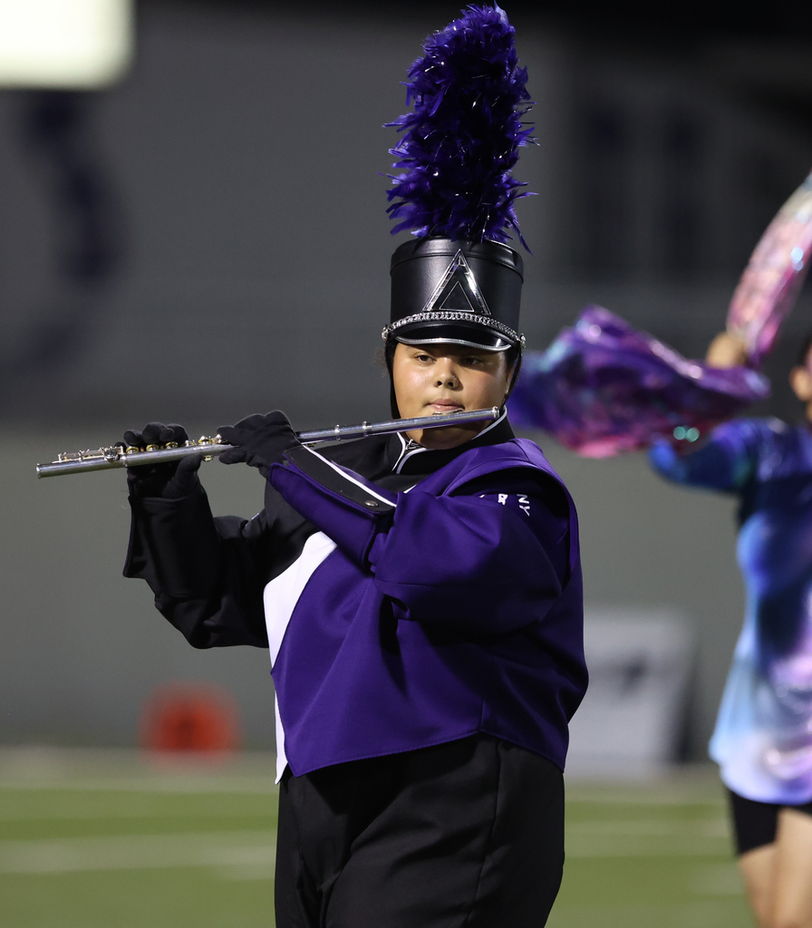 picture of student playing flute in marching band