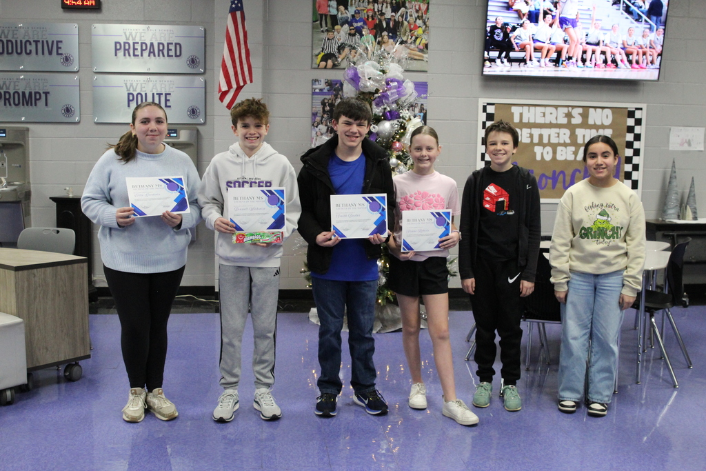 Picture of six students of the month standing in the commons area holding their certificates