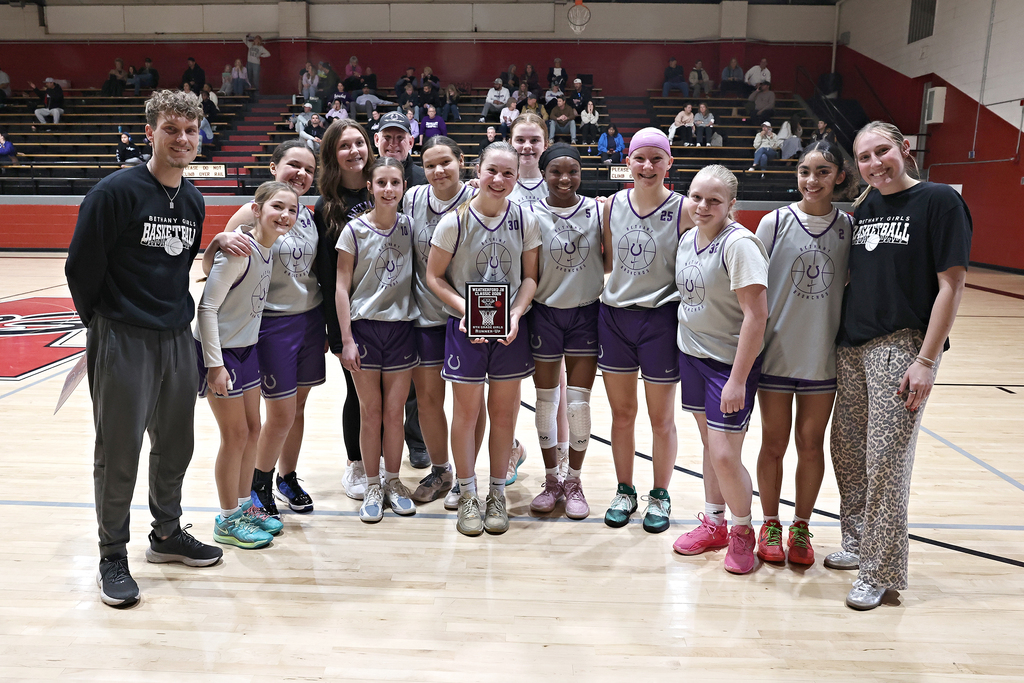 picture of the 8th grade girls basketball team holding their 2nd place plaque in weatherford tournament