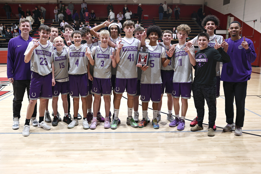 picture of 8th grade boys basketball team holding the championship plaque from the weatherford tournament