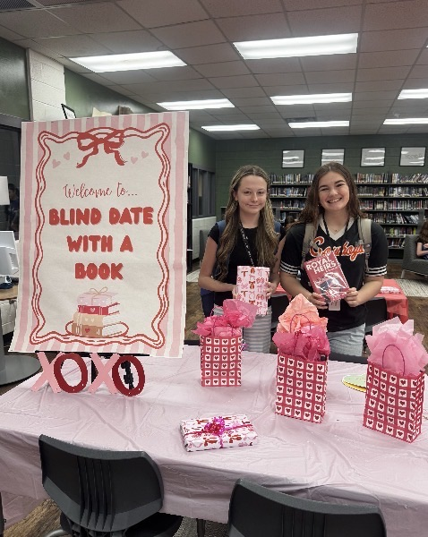 two students holding their books
