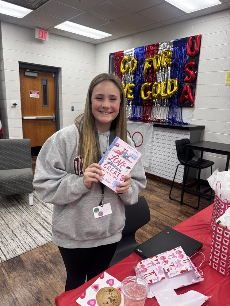One student holding a book