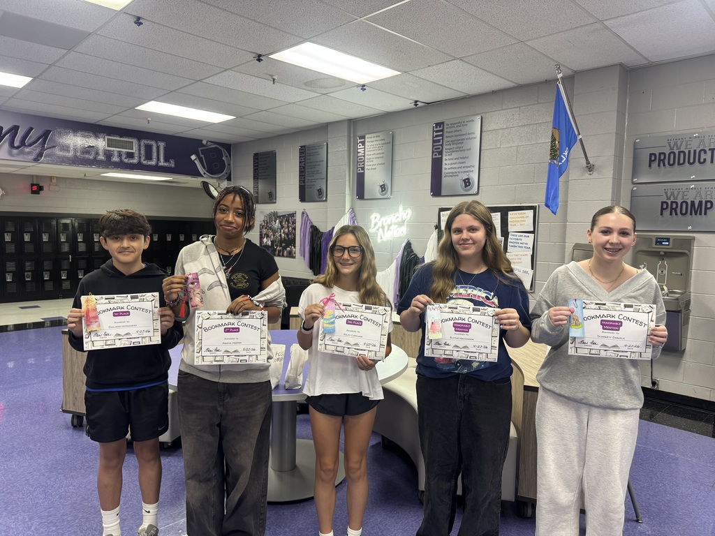 photo of the five students who won the book mark contest, holding their certificates and winning bookmarks