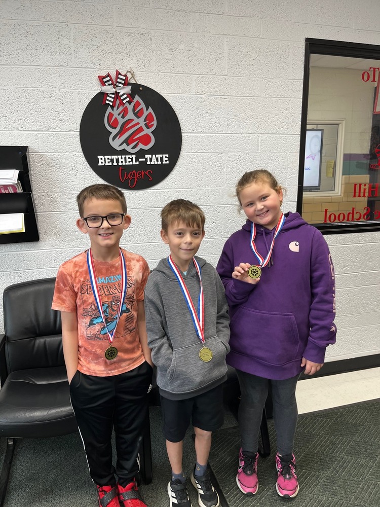 3 math award winners with their medals