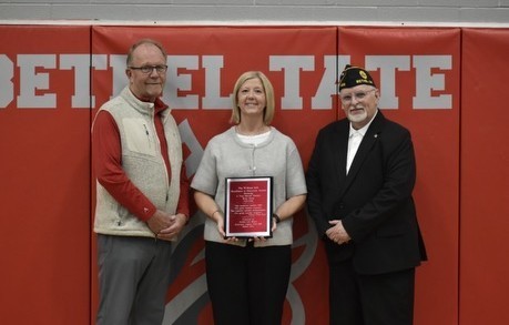 Kim Click with her award and two men