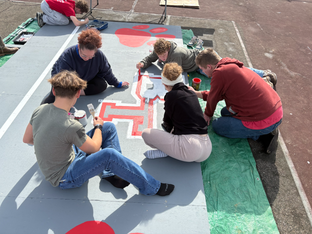 Students working on Eagle Scout project of creating a backboard for tennis to use for practice