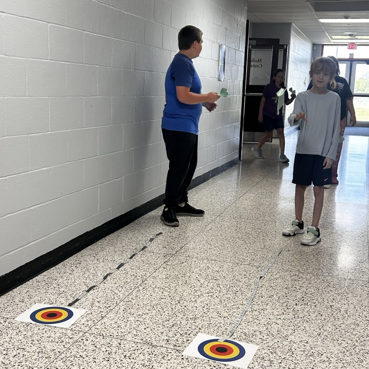 6th grade PLTW making paper airplane gliders to learn about the design process and using an engineer’s notebook to document their designs. 