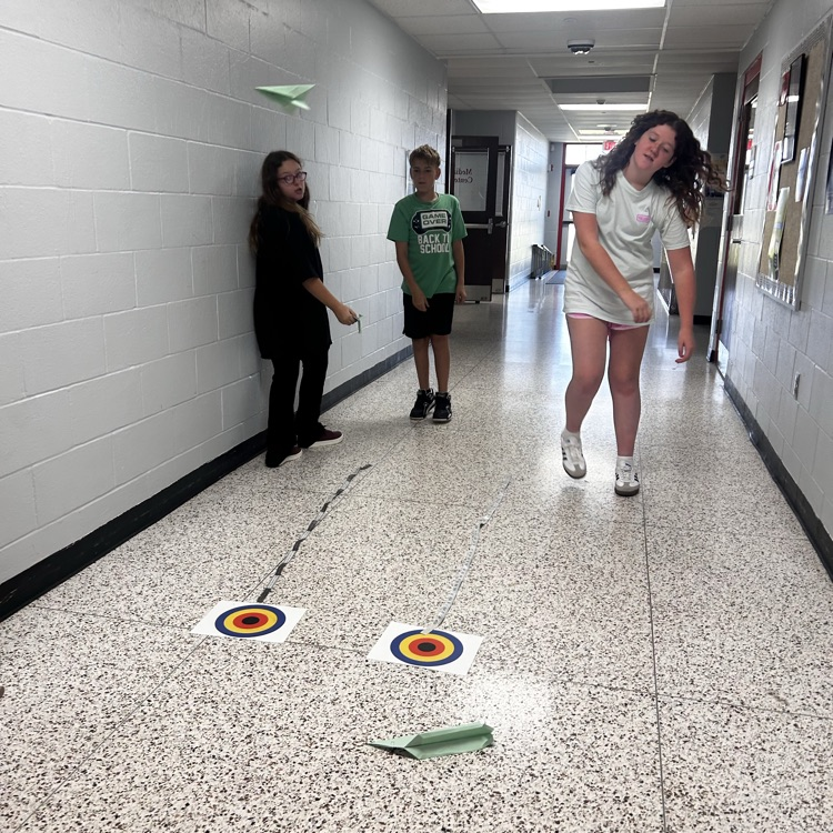 6th grade PLTW making paper airplane gliders to learn about the design process and using an engineer’s notebook to document their designs. 