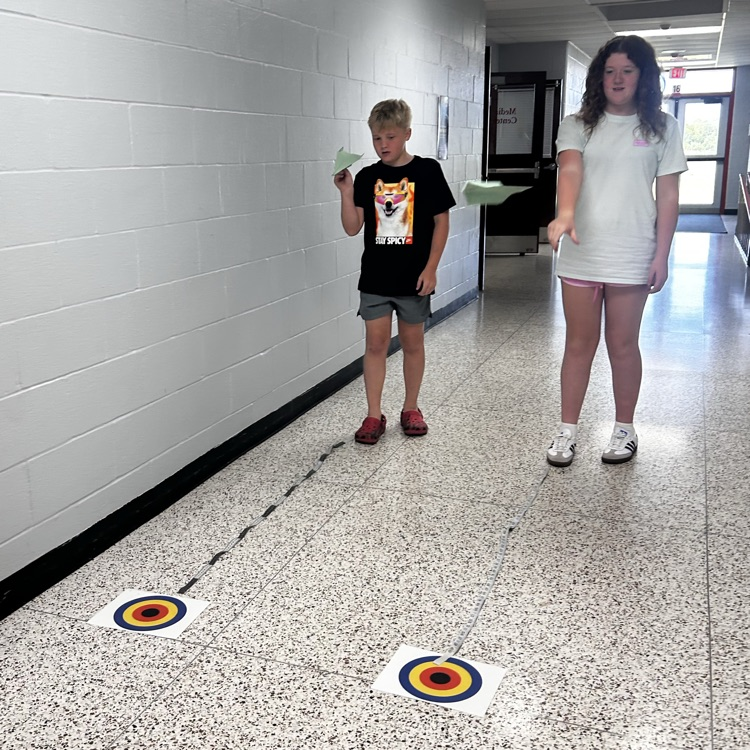 6th grade PLTW making paper airplane gliders to learn about the design process and using an engineer’s notebook to document their designs. 