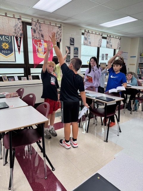 Students in Mrs. Starline’s language arts class used the “Stand Up, Hand Up, Pair Up" strategy to find partners and complete a vocabulary activity. 