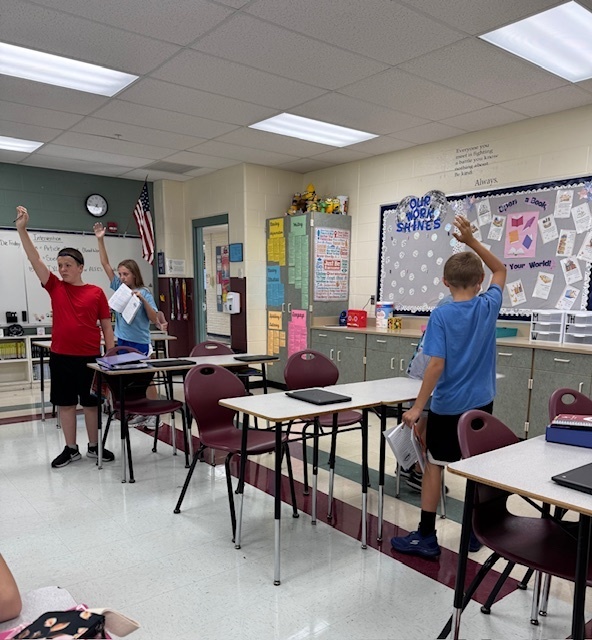Students in Mrs. Starline’s language arts class used the “Stand Up, Hand Up, Pair Up" strategy to find partners and complete a vocabulary activity. 