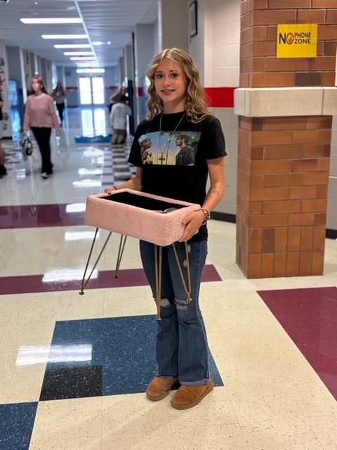 student with a foot stool
