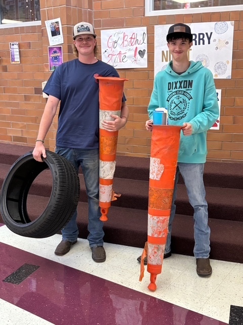 Students with orange cones and a car tired