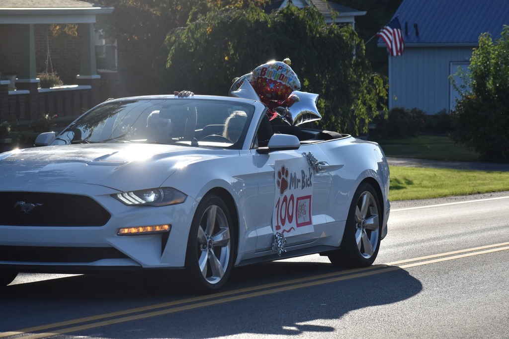 Mr. Bick with Superintendent Missy Kircher in 2023 homecoming parade mustang convertible