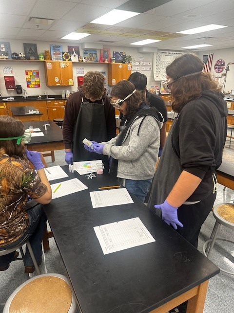 Science students busy with hands on lessons in investigative science
