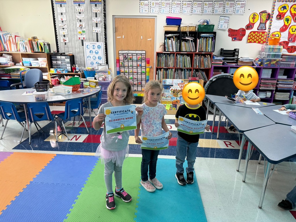 Students displaying their recognition certificates