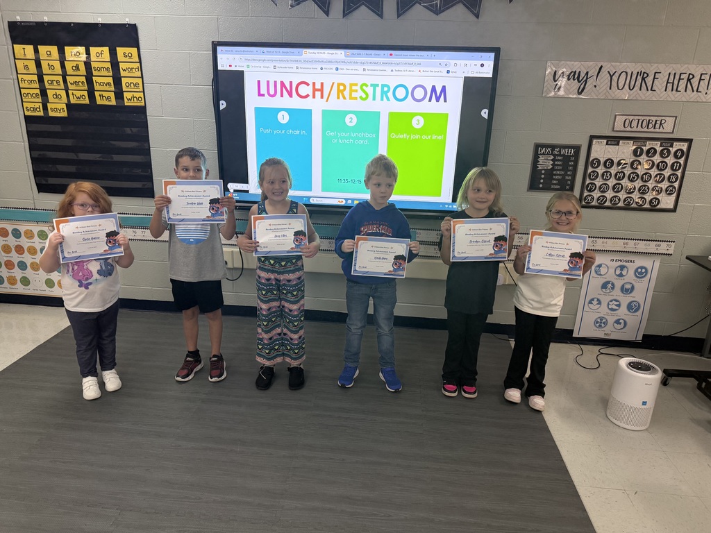 Students displaying their recognition certificates