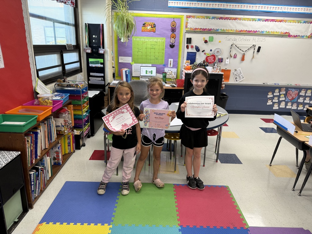 Students displaying their recognition certificates