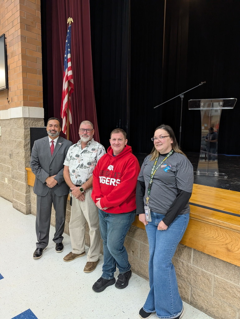 Guest Veteran Speaker Mr. Jones with several district staff members