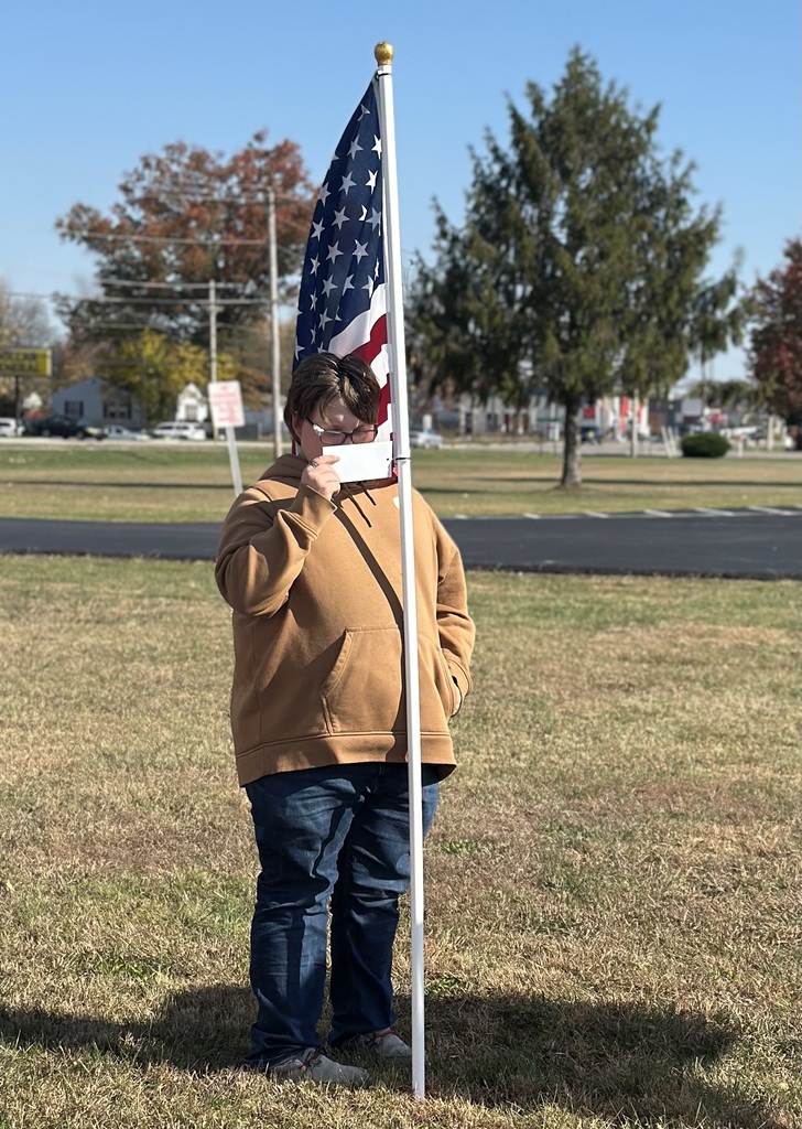 Students read the names through the flag field and honor our Veterans.
