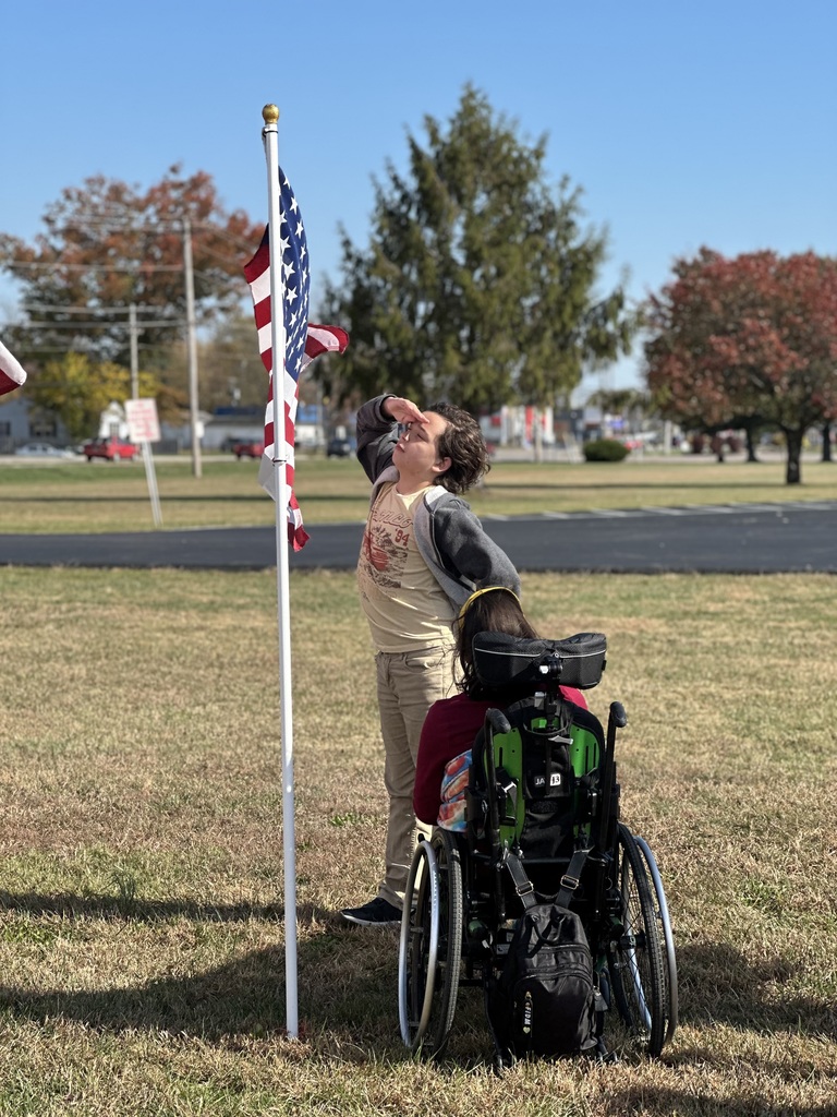 Students read the names through the flag field and honor our Veterans.