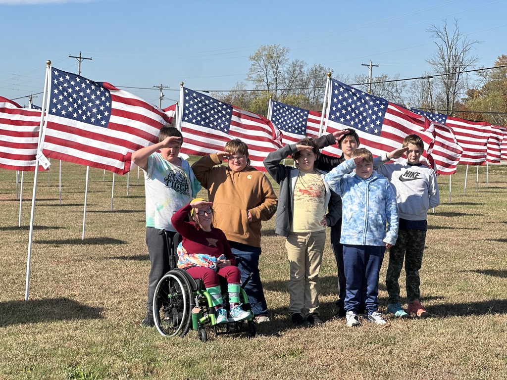 Students read the names through the flag field and honor our Veterans.