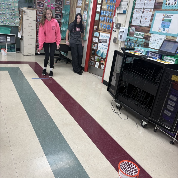 7th graders predicted how many baskets they thought they’d make out of 10, then took 10 real shots to test their accuracy. Using proportions, they calculated their percent error to compare their predictions to their actual results. 