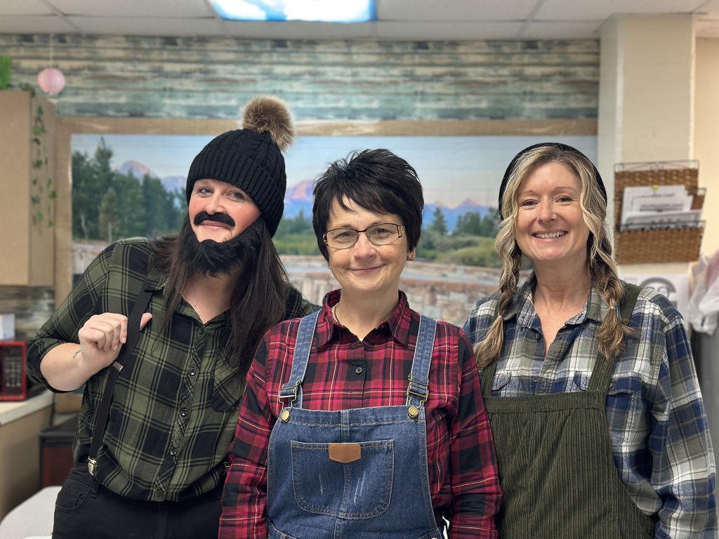 Students dressed as lumberjacks getting ready to cut down Christmas trees for the day after Thanksgiving.