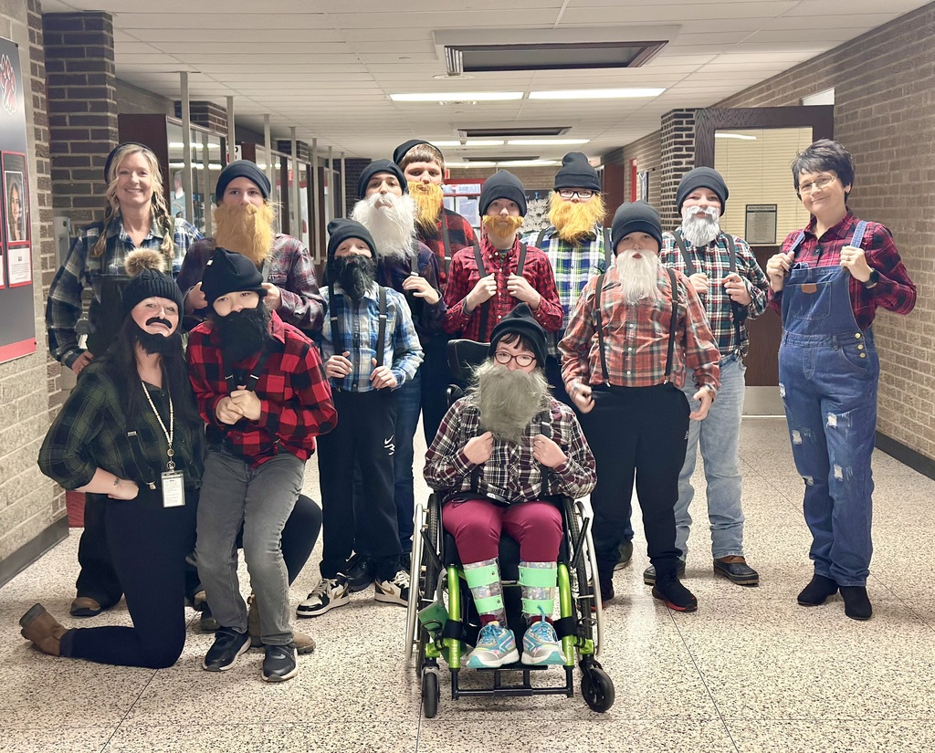 Students dressed as lumberjacks getting ready to cut down Christmas trees for the day after Thanksgiving.
