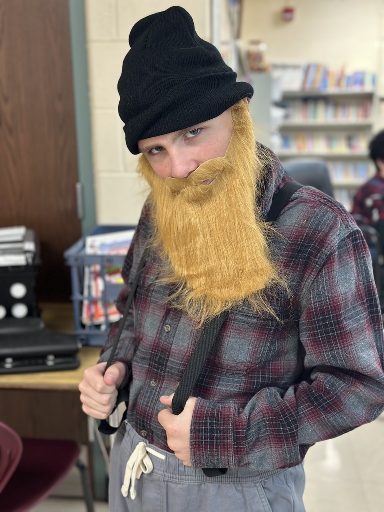 Students dressed as lumberjacks getting ready to cut down Christmas trees for the day after Thanksgiving.
