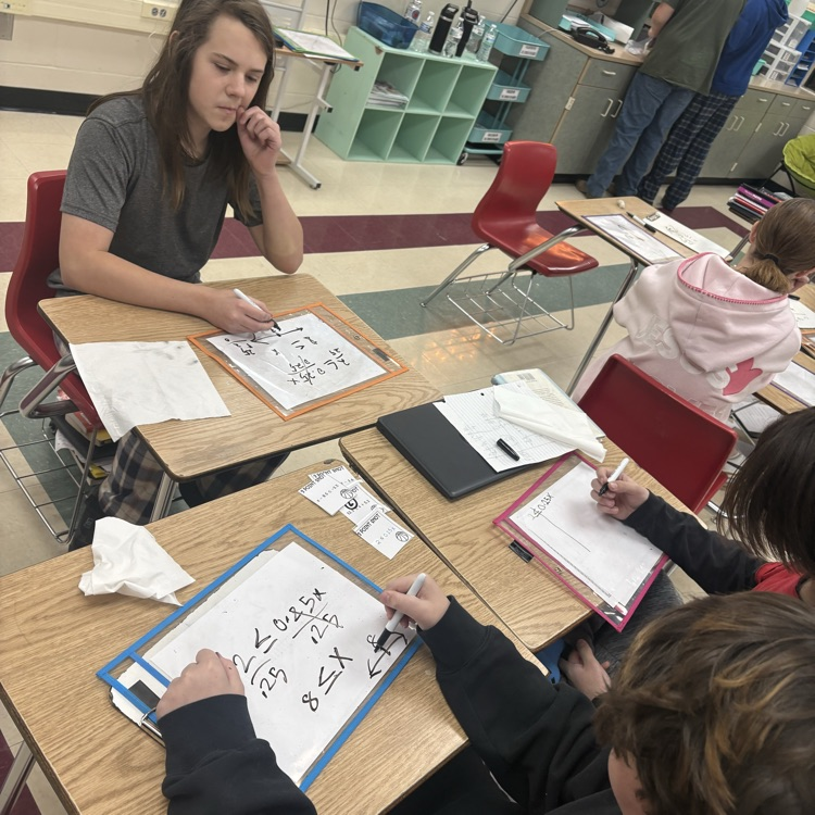 7th grade students collaborated in groups to solve and graph inequalities, choosing from multiple levels of questions to challenge their understanding.