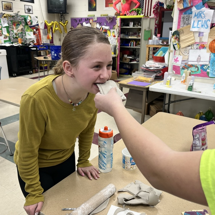 For FB:  7th graders finished sculpting their clay junk food this week, so next week they will be painting them.  And as you see, some of our students take their art project VERY seriously!  Violet really wanted her’s to look realistic 😃 