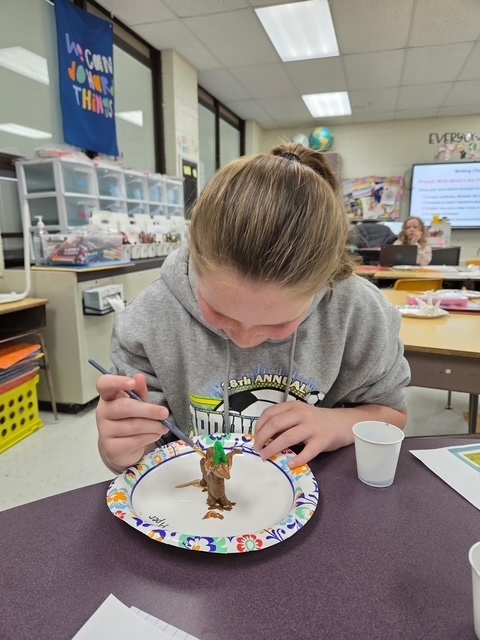 student working on science art project
