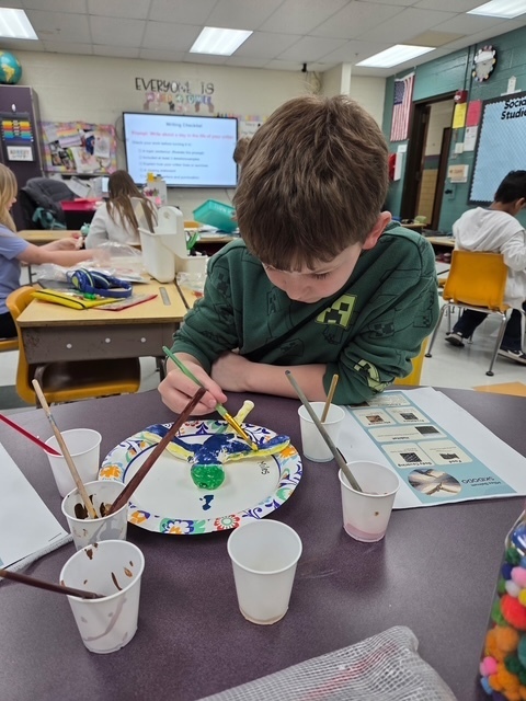 student working on science art project
