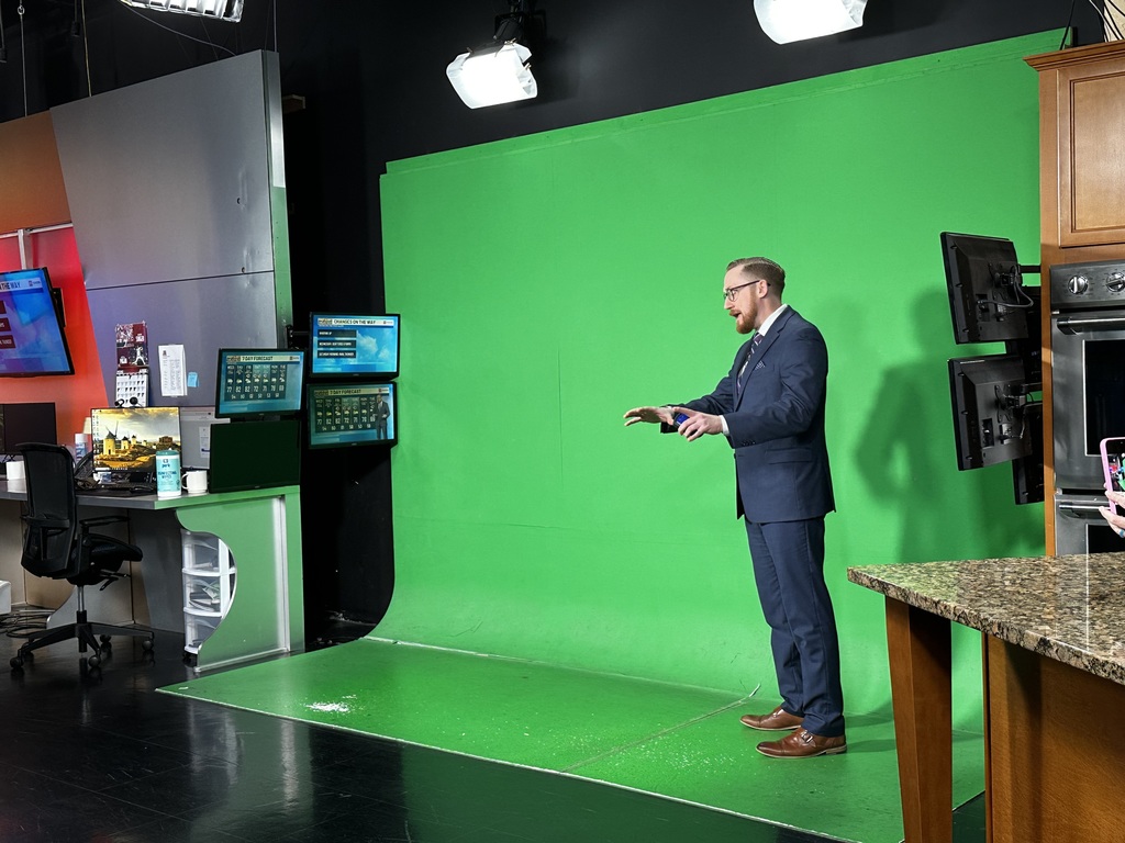 Bethel-Tate Content Creator students tour fox 19 news studio. As shown meteorologist in front of the green screen