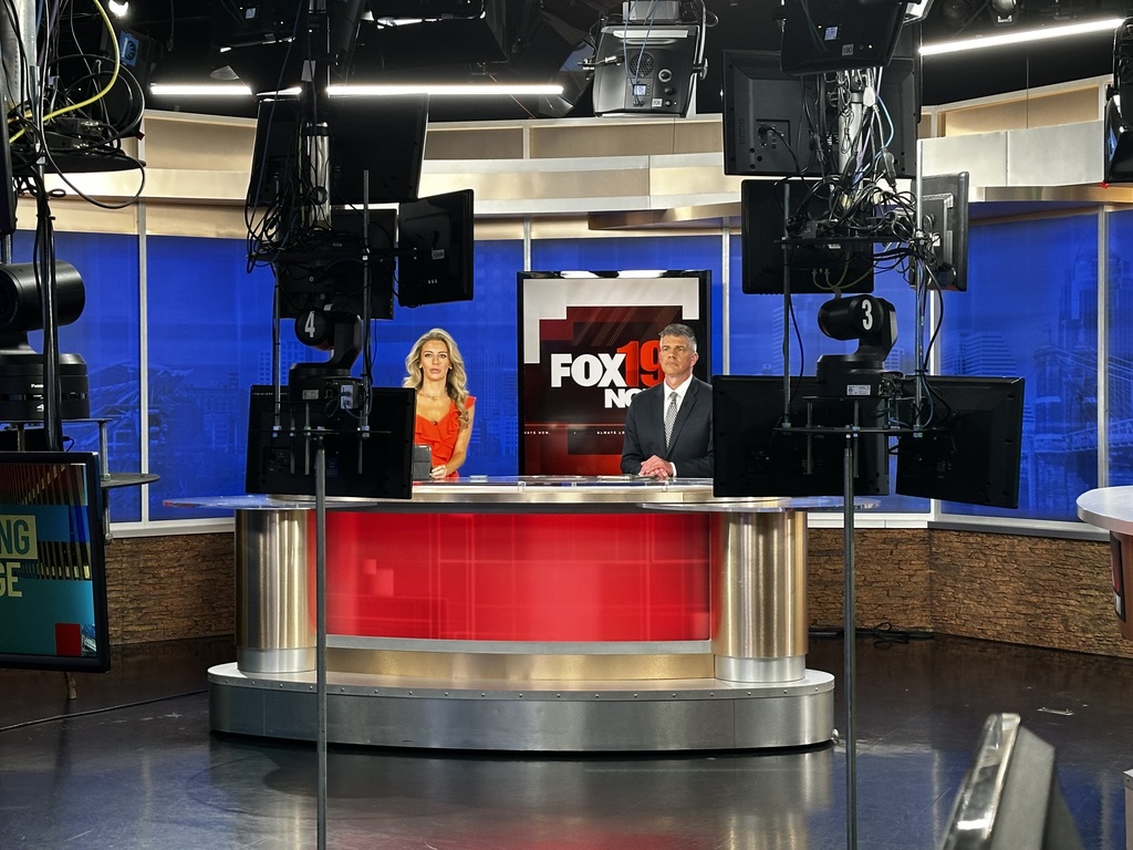 Bethel-Tate Content Creator students tour fox 19 news studio. As shown, two news anchors at the desk
